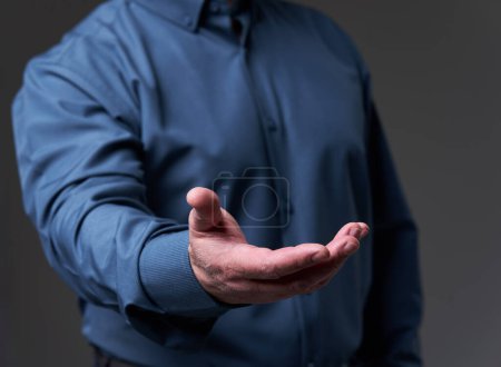 Photo for Hand of a business man, outstretched, displaying something or requesting, conceptual shot - Royalty Free Image