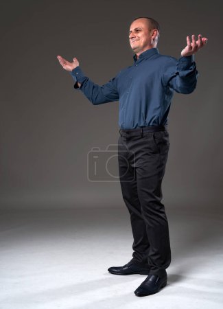 Photo for Full body portrait of a businessman with a voila gesture, arms stretched - Royalty Free Image