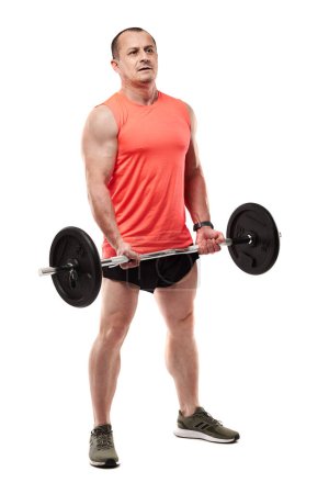 Photo for Mature athletic man in pink tee doing fitness workout with barbell and weights, isolated on white background - Royalty Free Image