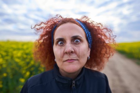 Photo for Wide angle funny closeup shot of a woman with a shock expression - Royalty Free Image