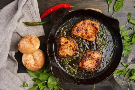 Photo for Beautifully done tenderloin steak in a cast iron skillet, flat lay shot from above - Royalty Free Image