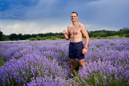 Photo for Kickboxer fighter training in a lavender field in full bloom - Royalty Free Image
