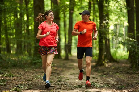 Photo for Runners couple endurance running on forest trails - Royalty Free Image