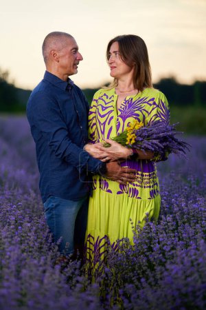 Photo for Portrait of a romantic couple in a lavender field at sunset - Royalty Free Image