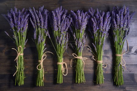 Photo for Bouquets of freshly picked fragrant lavender flowers on a wooden board - Royalty Free Image