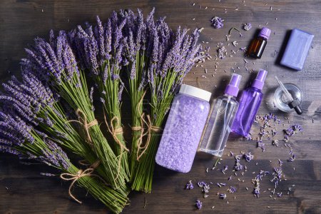 Photo for Lavender products along few bouquets on a wooden board - Royalty Free Image