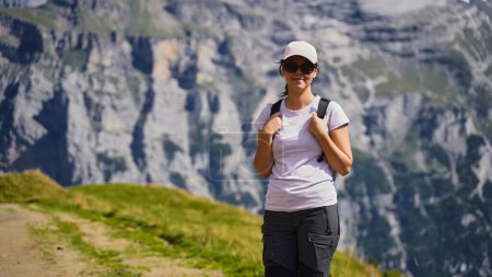 Photo for Young woman hiker on a hiking trail in the Swiss Alps - Royalty Free Image