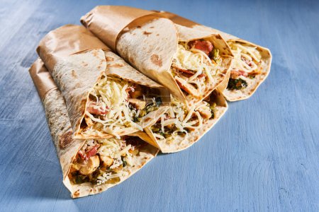 Photo for Fajitas rolls on a wooden blue board, stacked - Royalty Free Image