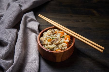 Photo for Thai recipe of boiled and fried rice with mushrooms and herbs and veggies in a rustic bowl - Royalty Free Image