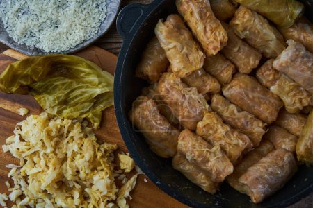 Photo for Cabbage rolls with pork meat and rice, sarmale, a traditional Romanian dish, in preparation - Royalty Free Image