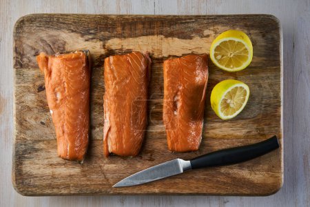 Foto de Filetes de salmón ahumado en una tabla de madera en primer plano - Imagen libre de derechos