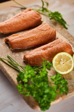 Photo for Smoked salmon fillet steaks on a wooden board in closeup - Royalty Free Image