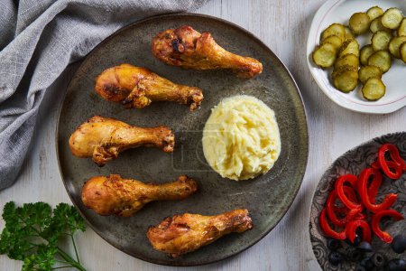 Photo for Closeup of grilled chicken drumsticks made with asian flavours and recipe, on a white wooden board - Royalty Free Image