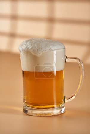 Foto de Pinta de cerveza en varias etapas de espuma sobre fondo beige - Imagen libre de derechos