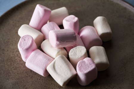 Photo for Closeup of a pile of marshmallows on a rustic plate - Royalty Free Image