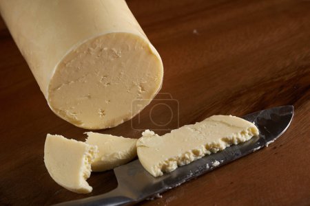 Photo for Homemade traditional butter in closeup on a wooden board - Royalty Free Image