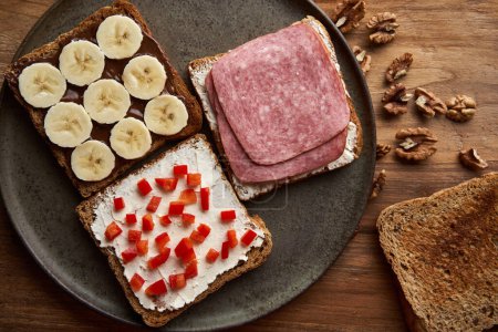 Photo for Various sandwiches with salami, chocolate and banana, cream cheese and red pepper for breakfast or brunch - Royalty Free Image