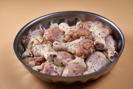 Photo for Closeup of seasoned raw chicken drumsticks, legs, ready for the grill - Royalty Free Image
