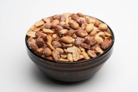 Photo for Oven baked salted peanuts in a bowl, closeup studio shot - Royalty Free Image