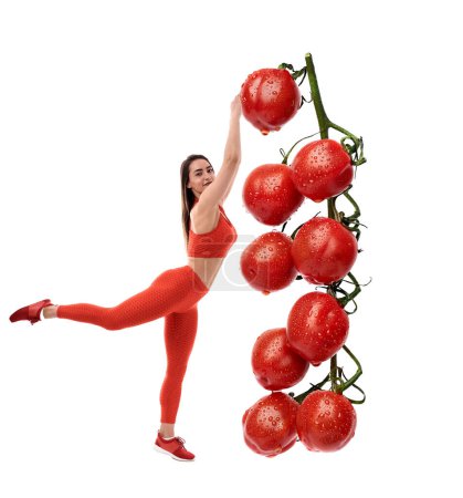 Foto de Concepto de dieta con una mujer fitness que llega a la cima de una enorme vid con tomates cherry, llenos de vitaminas - Imagen libre de derechos