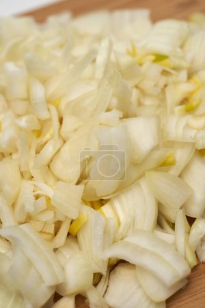 Photo for Freshly chopped white onion on a wooden board in closeup shot - Royalty Free Image