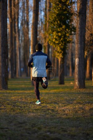 Foto de Atleta corriendo en el parque, vista desde atrás - Imagen libre de derechos