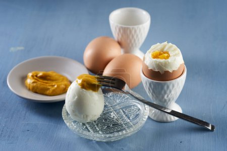 Photo for Hot hard boiled eggs on a blue wooden background, ready to eat - Royalty Free Image
