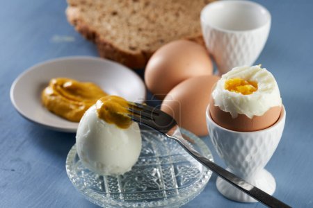 Photo for Hot hard boiled eggs on a blue wooden background, ready to eat - Royalty Free Image