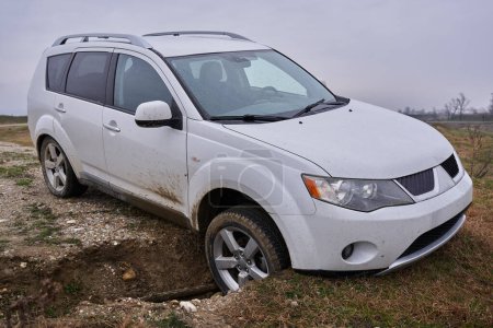 Off road SUV car crashed into a ditch on a track course 