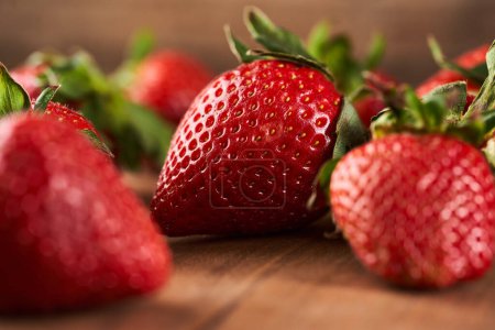 Photo for Juicy strawberries, freshly picked, on a rustic wooden board - Royalty Free Image