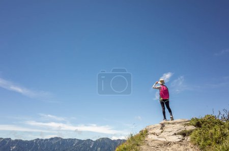 Photo for Asian mountain climbing woman pointing at far away in Hehuan mountain, Taiwan - Royalty Free Image