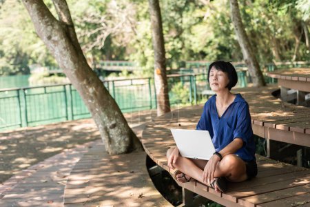 Photo for Woman using laptop, concept of working at outdoor - Royalty Free Image