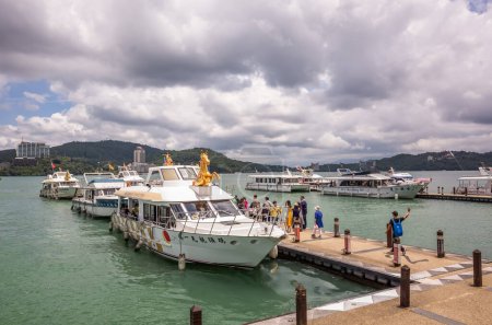 Photo for Nantou, Taiwan - May 30th, 2019: tourists and boats at Xuanguang temple pier in Sun Moon Lake, Nantou, Taiwan - Royalty Free Image