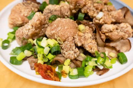 Photo for Crispy fried chicken with green onions and chili on a plate. - Royalty Free Image