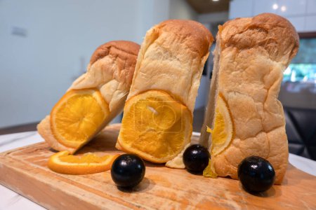 Photo for Loaf of bread with baked orange slices. - Royalty Free Image