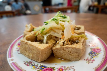 Plate of stinky tofu with pickled vegetables.