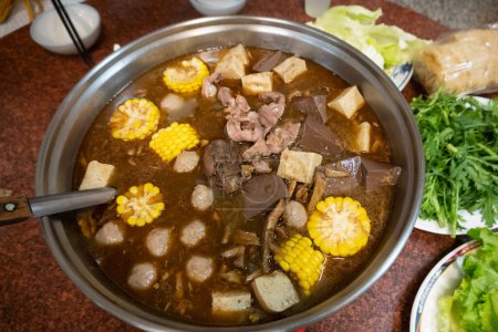 Hot pot with lamb, tofu, and corn.
