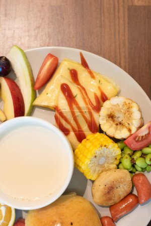 Photo for Generous breakfast spread with fruit, eggs, and soup. - Royalty Free Image