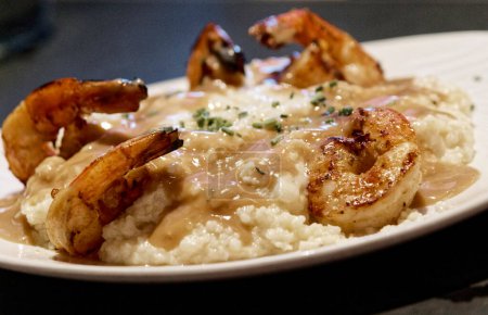 Photo for Shrimp and Grits with Sauce on Plate - Royalty Free Image