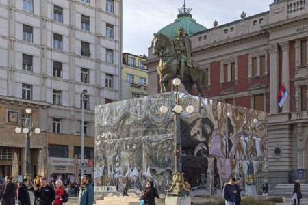 Foto de Belgrade, Serbia - December 31, 2022: Equestrian Statue of Prince Mihailo Monument With Temporary Metal Box and People Walking Arround at Republic Square Winter. - Imagen libre de derechos