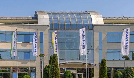 Photo for Gornji Milanovac, Serbia - May 26, 2022: Company Metalac Headquarters Modern Office Building With Flags. - Royalty Free Image