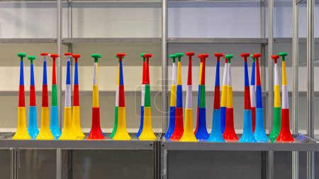 Téléchargez les photos : New Long Plastic Vuvuzela Horn for Sale at Rack - en image libre de droit