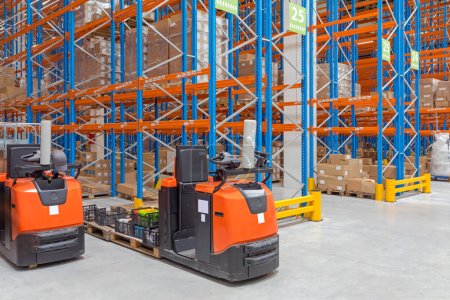 Two Order Picker Forklift Trucks in Distribution Warehouse