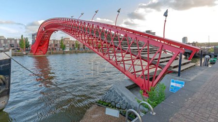 Photo for Amsterdam, Netherlands - May 17, 2018: Red Bridge Pythonbrug Over Canal in Capital City East. - Royalty Free Image