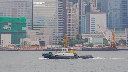 Photo for Hong Kong, China - April 23, 2017: Tug Boat Shunde Sct South China Towing Company Passing Victoria Harbour Spring Day. - Royalty Free Image