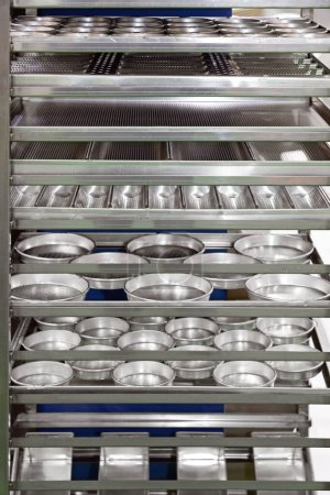 Photo for Perforated Cassette Flat Trays Pans in Tin Trolley Rack Bakery Equipment - Royalty Free Image