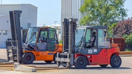 Photo for Large Diesel Powered Forklift Trucks at Storage Yard Sunny Day - Royalty Free Image