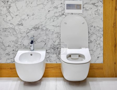 Wall Mounted White Ceramic Bidet and Toilet Bowl Set in Marble Bathroom