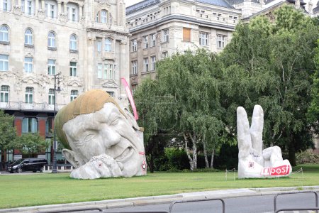 Photo for Budapest, Hungary - July 13, 2015: Giant Sculpture Poked His Head and Fingers a Sculpture Named Repost at Szechenyi Istvan Square in Capital City. - Royalty Free Image