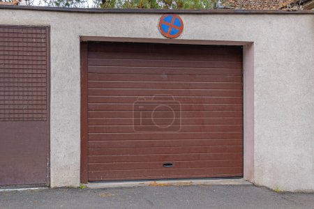 Foto de Cerrado puerta de rollo de garaje marrón con ninguna señal de tráfico de estacionamiento - Imagen libre de derechos